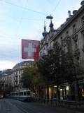 the tram and flag october morning on bahnhofstrasse zürich switzerland by roadsofstone